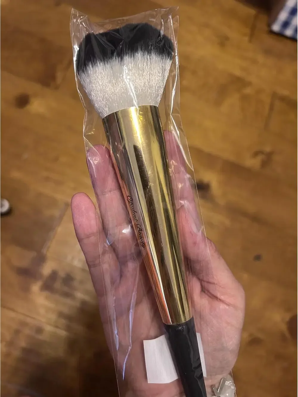 Gold-Tone Makeup Powder Brush with Black and White Bristles